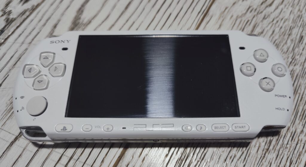 PSP 3000 laying on the table with display turned off. Intro into PSP reshell