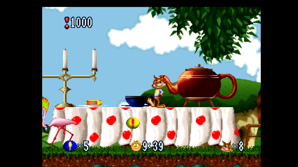 Screenshot from Bubsy in Fractured Furry Tales released on Atari Jaguar. Bubsy stands on the table, smiles into the camera near a giant teapot.