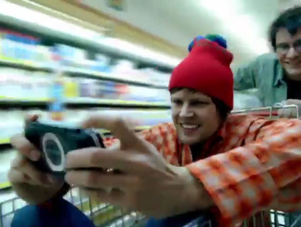 PSP commercial where a guy plays PSP in shop's cart