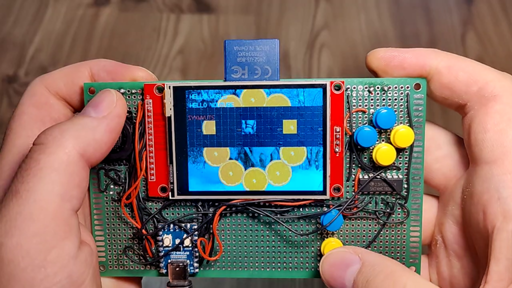Different electronic components slapped onto a breadboard. Display is working and showing some graphics.